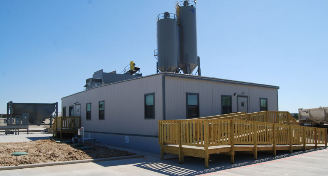 outside-of-a-modular-structure-with-a-wooden-ramp-in-the-front outside-of-a-modular-structure-with-a-wooden-ramp-in-the-front